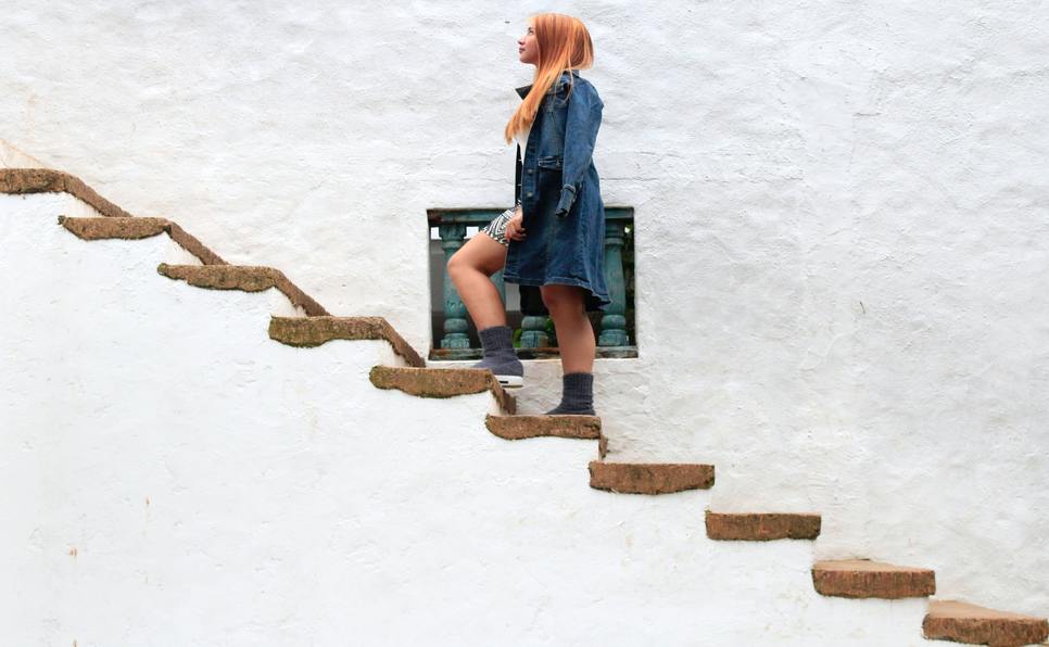 Redhead woman climbing stairs
