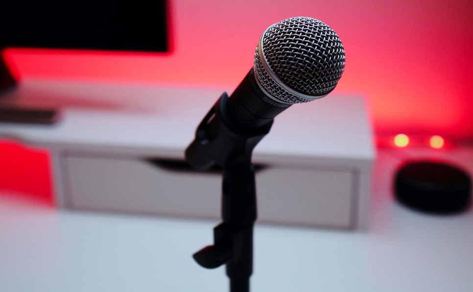 Microphone against a red background representing the best podcasts about the publishing business