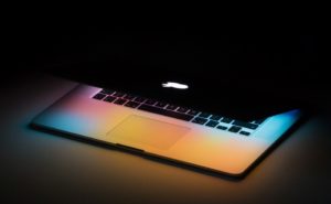 Half open MacBook with colored lights