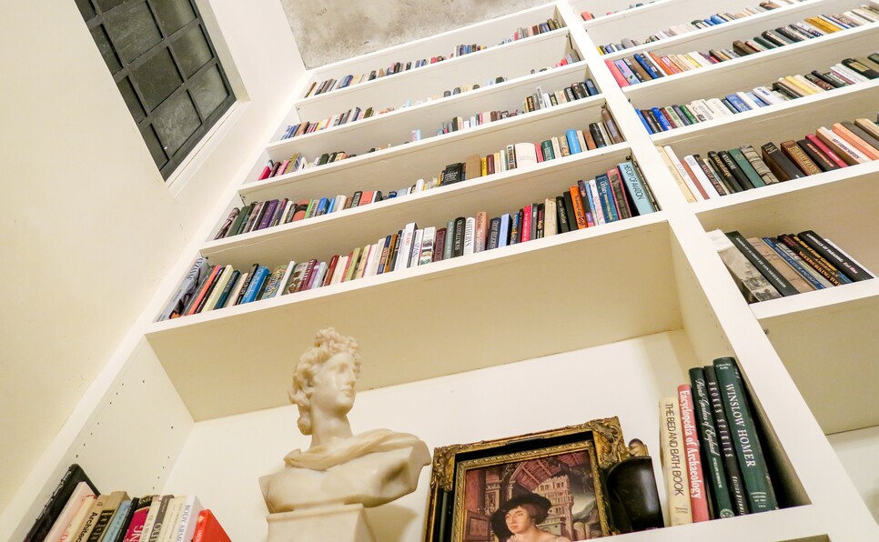 A bust against a wall of books indicating a Goodreads author profile