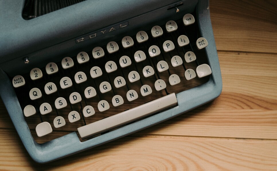 A blue typewriter to denote what is a query letter