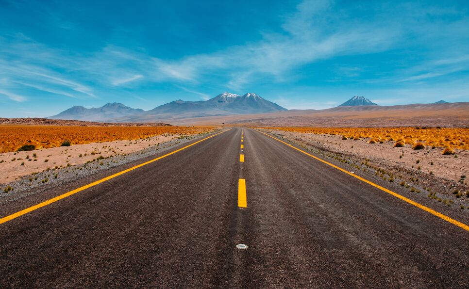 A lonely desert road and blue mountains to inspire scene writing prompts